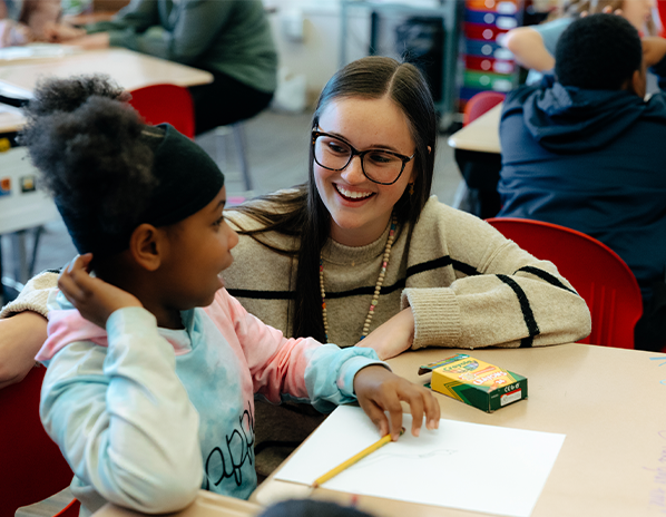 teacher working with a student