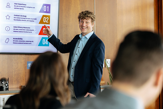 Business student presenting to classmates at the University of Northern Iowa, gaining real-world business experience