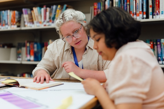 Student teacher working with an elementary student.