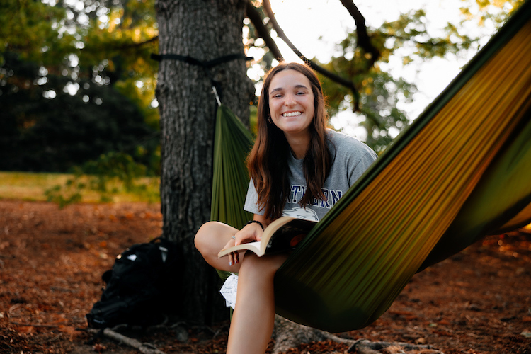 Student in hammock on campus