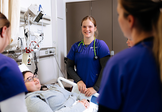 Nursing student smiling in patient room