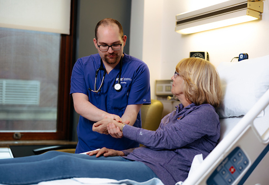 Nursing student working with patient