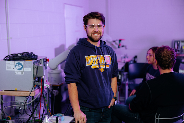 Student in front of engineering equipment