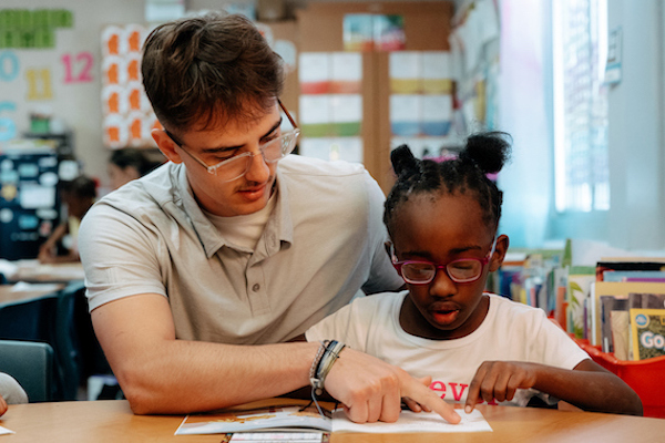 Student teaching in a classroom with a child