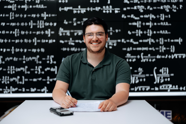 Student in front of blackboard