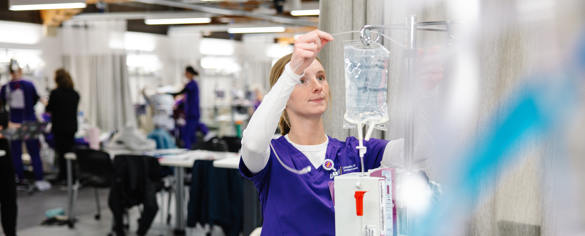 Nursing student working on a fluid bag