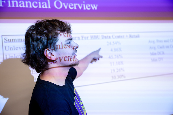 Student at a white board in a classroom