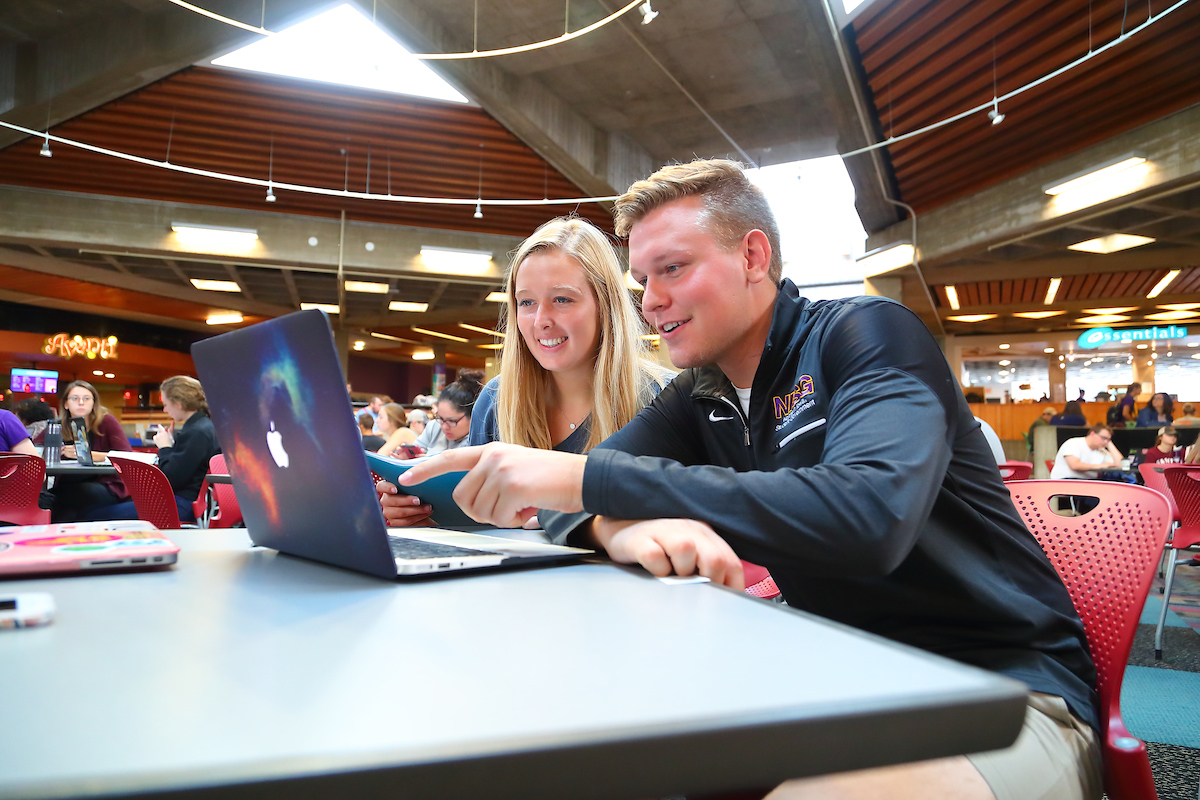 students in maucker union on laptop