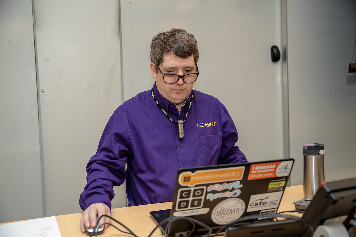 uni computer science professor in front of laptop
