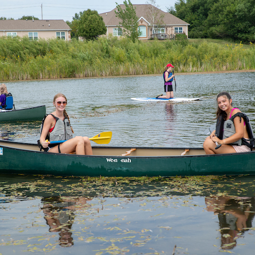 Students in a canoe on the pond